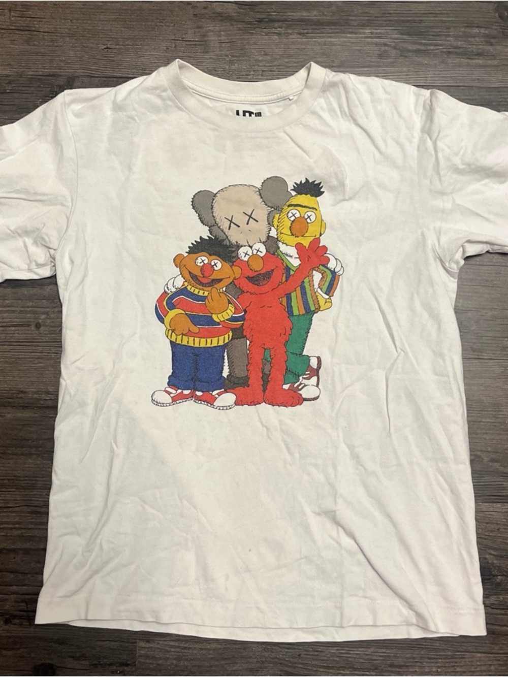 KAWS White Tee with Red, Yellow, Green & Blue Cartoon Trio